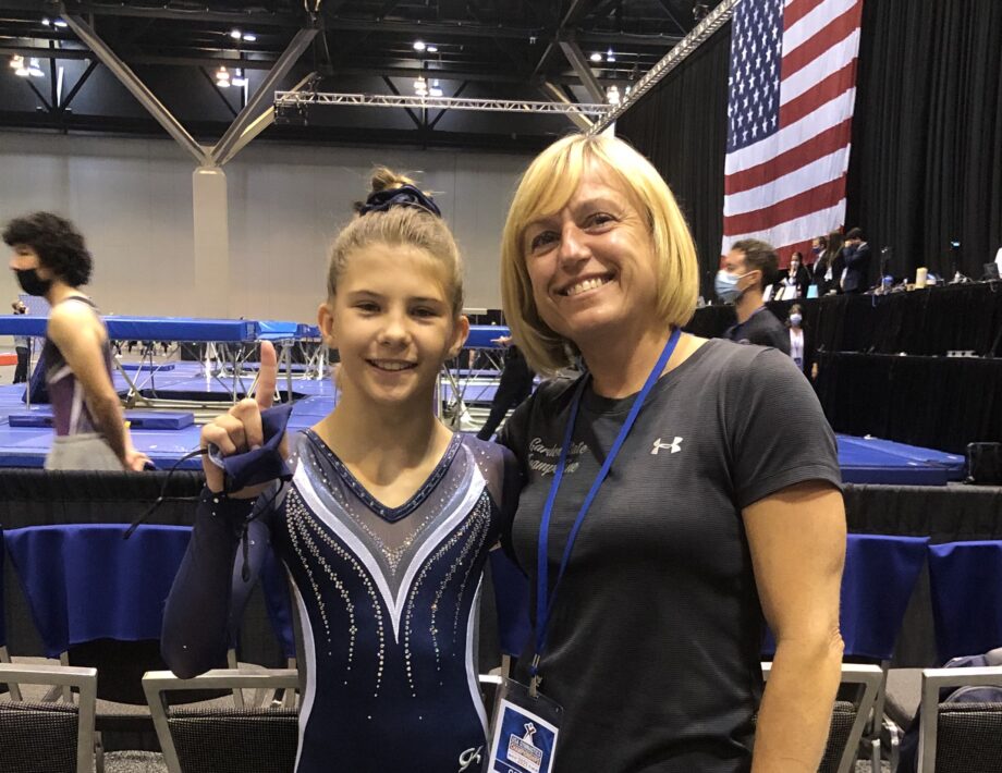 Coach Natasha and a gymnast.