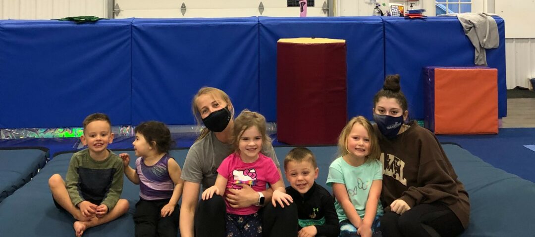 Coach Nastia and several kids after a gym practice.