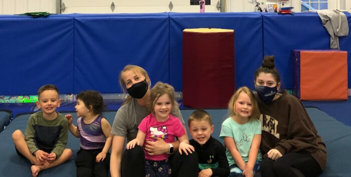 Coach Nastia and several kids after a gym practice.