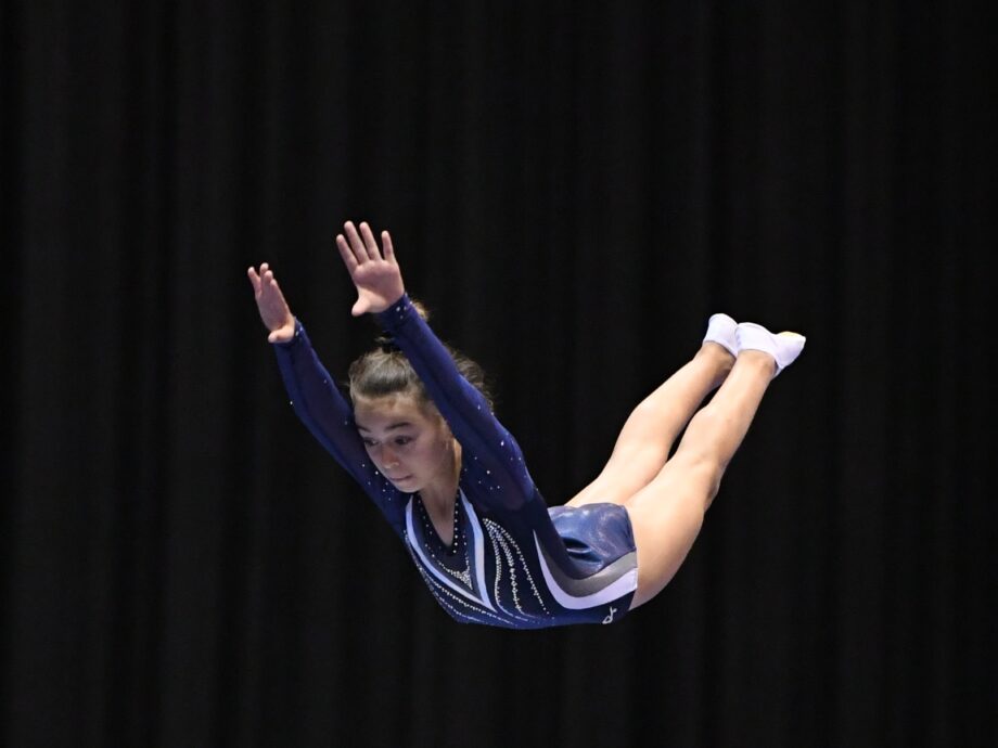 A girl in the air mid-flip.