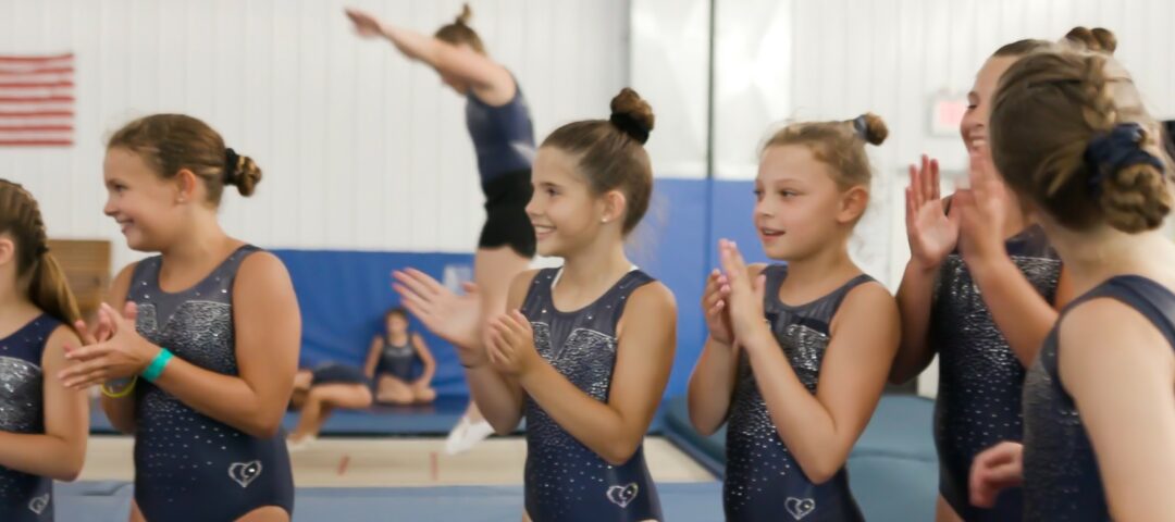 Several girls in a semi-circle clapping.