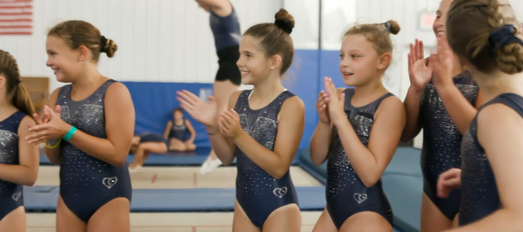 girls clapping in unitards.