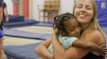 nastia and a girl hugging.